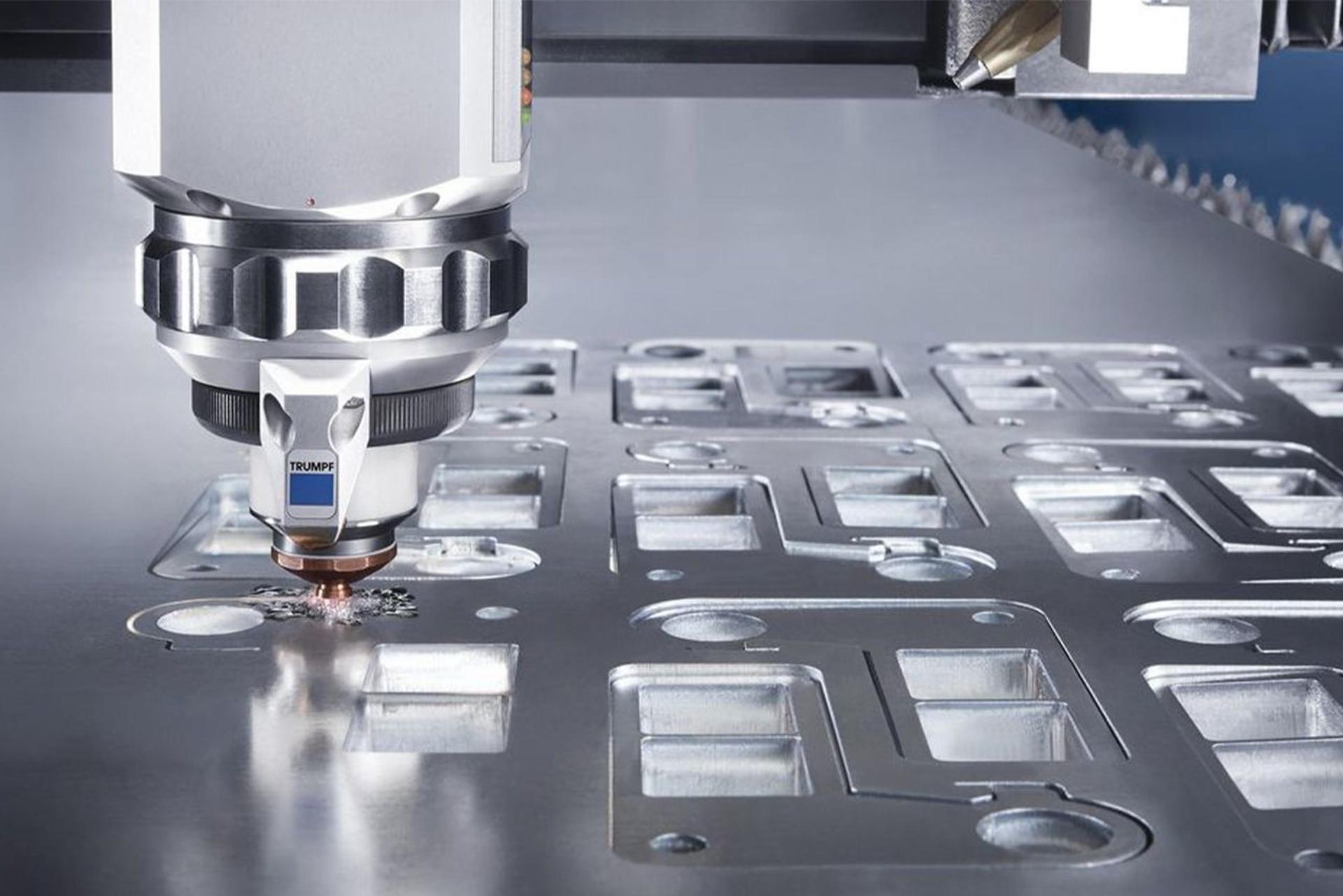 Laser cutting machine from JWM Metaalservice cutting shapes into a sheet of metal.